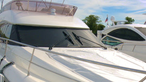 Build your own exterior windshield sun screen to help keep the sun's heat out, but still provide some visibility from inside the boat's cabin
